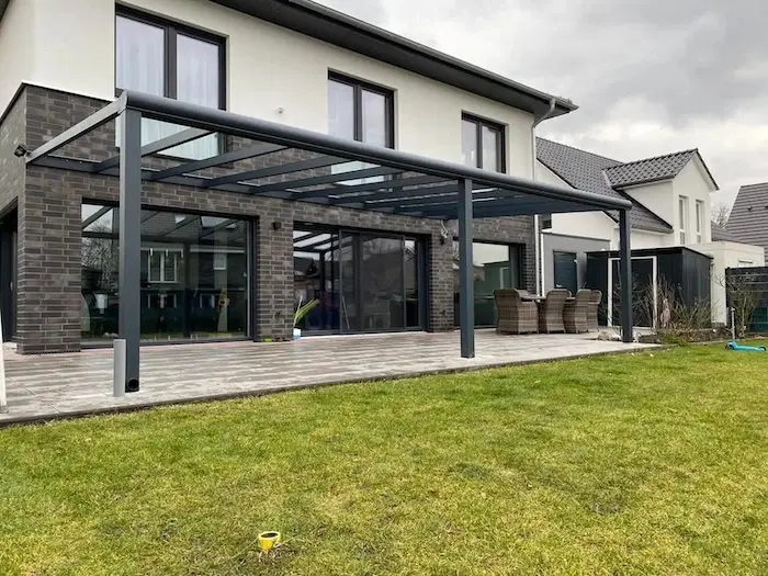 Breite Veranda mit Glasdach und offenen Seiten sowie Vorderseite