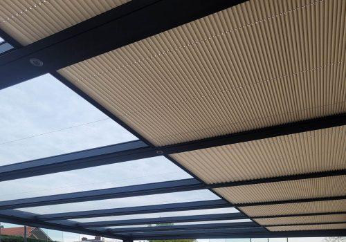 Pleated blinds on a canopy with a glass roof